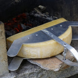 Raclette Wheel holder with cheese at open fire