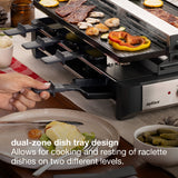 A close-up of a Zyliss dual-zone griddle with food cooking on the upper plate, a hand pulling the lower plate out, and overlaid text describing the dual-zone dish tray design.