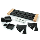 Collection of black and wooden raclette tools on a white background