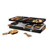 Electric raclette grill with food on a white background